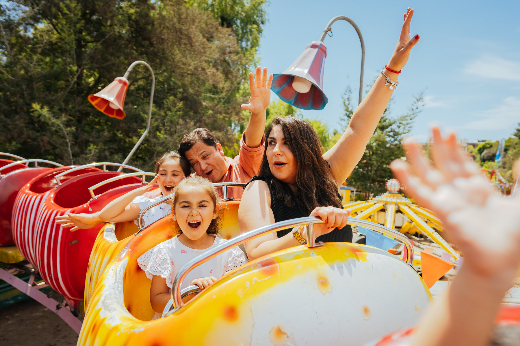 A family laughing together on an amusement ride