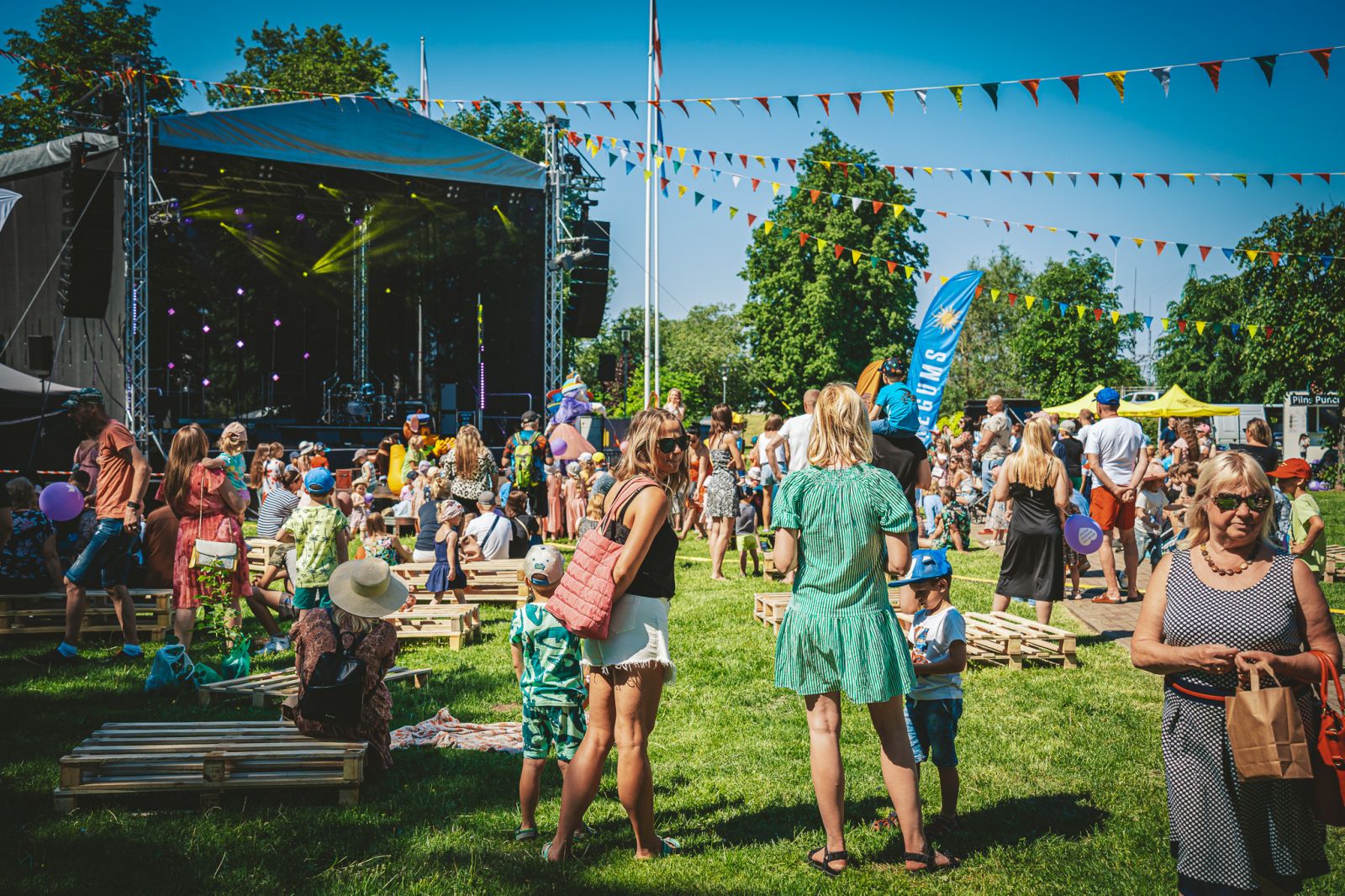 Families gathering at a sunny outdoor community festival