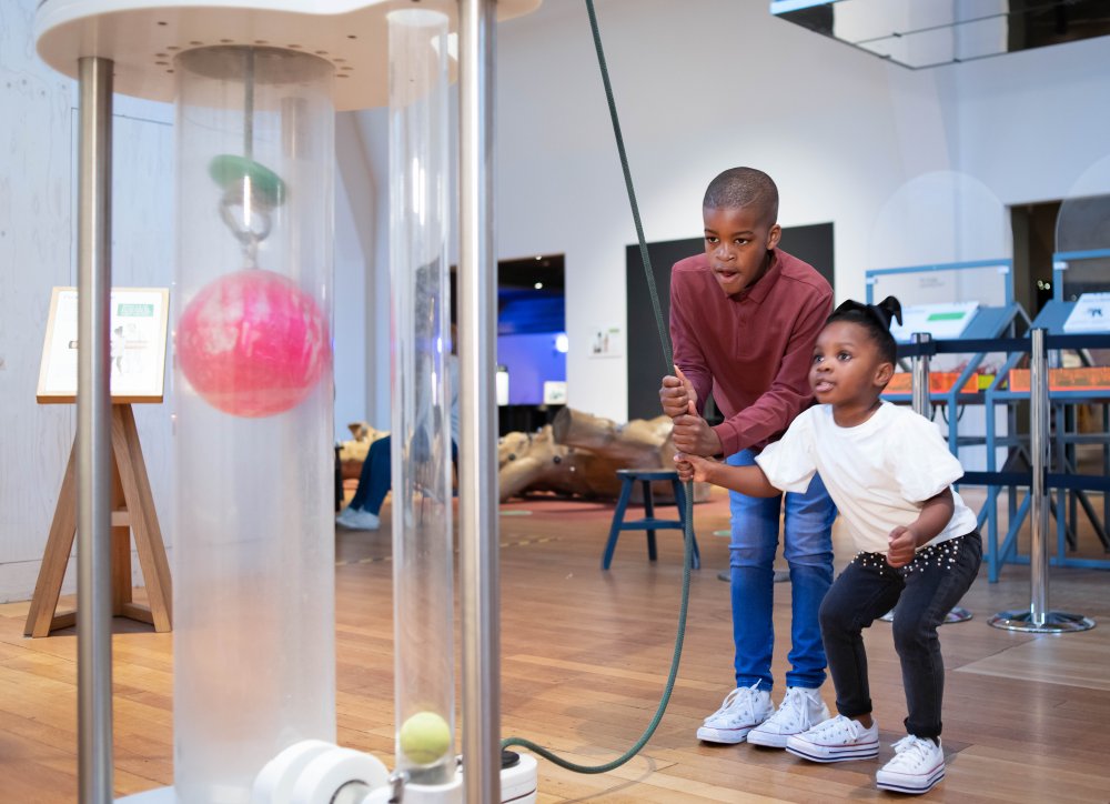 Two children exploring a hands-on museum exhibit